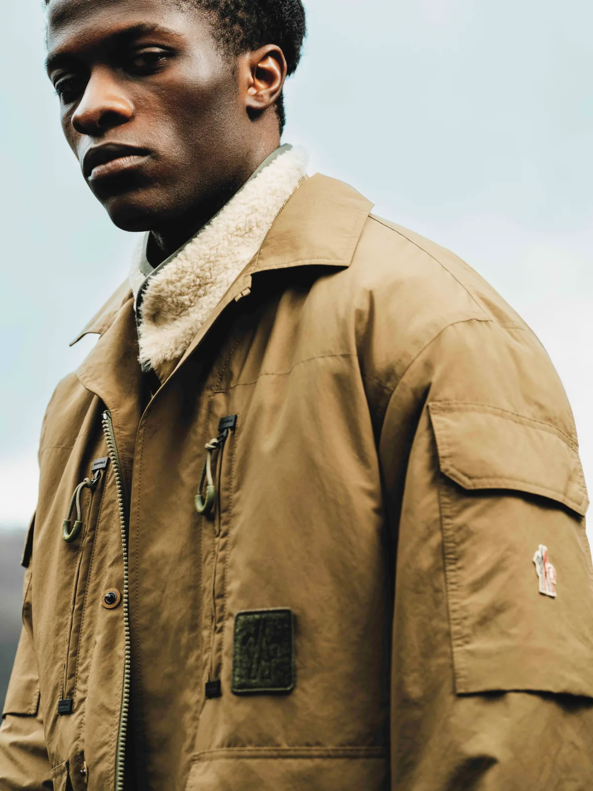 Fashion still from RESH Moncler Grenoble campaign — wide frame with model in jacket