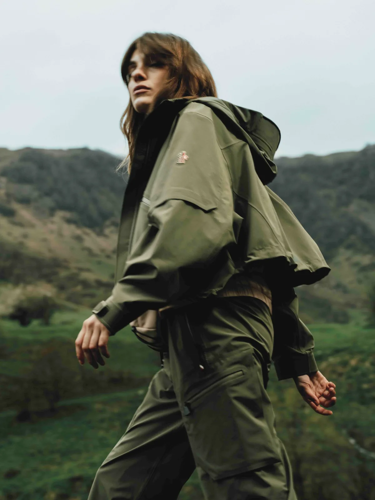 Fashion still from RESH Moncler Grenoble campaign — wide frame with model and green jacket